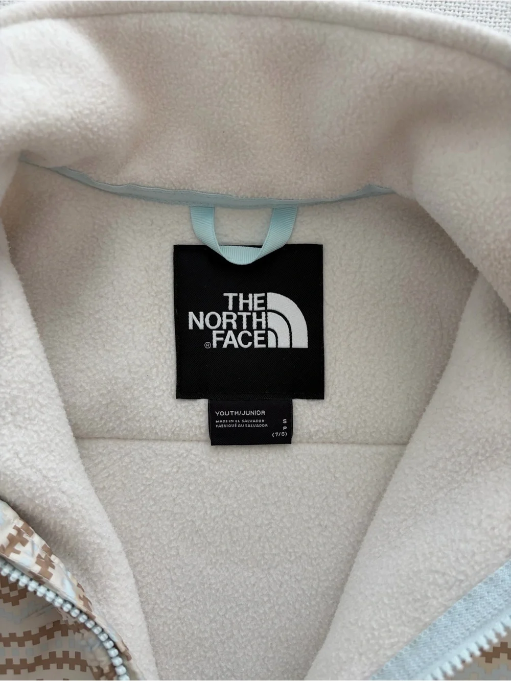 The North Face Youth Cream Fleece Jacket with Tan Pattern & Light Blue Zippers
